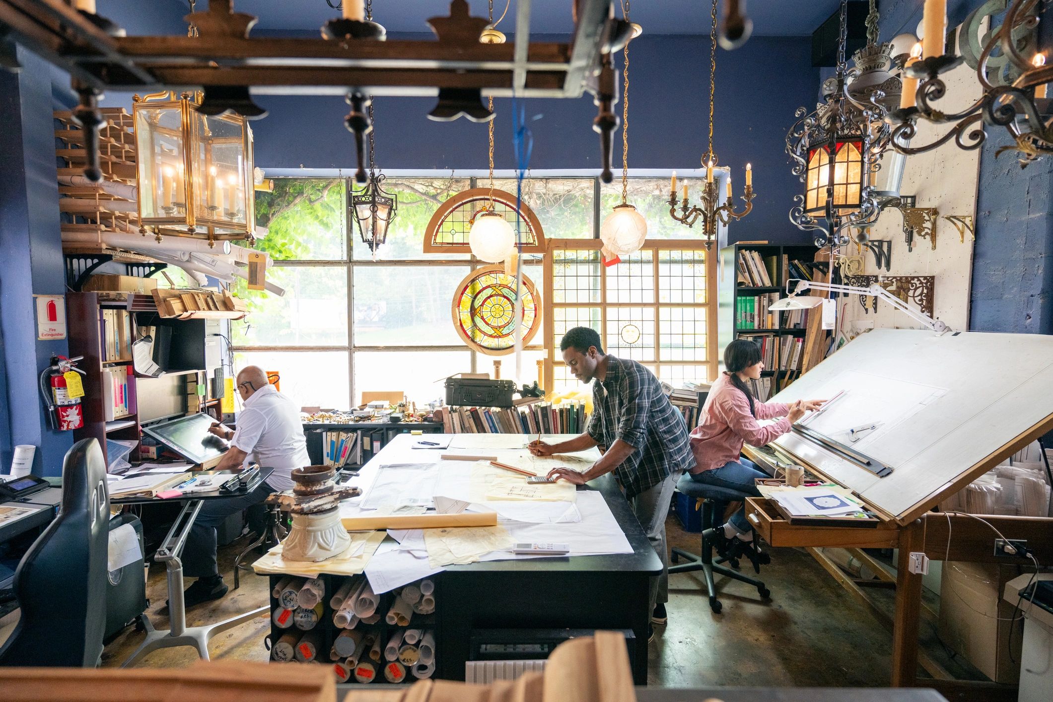 Team collaborating on architecture plans in a studio