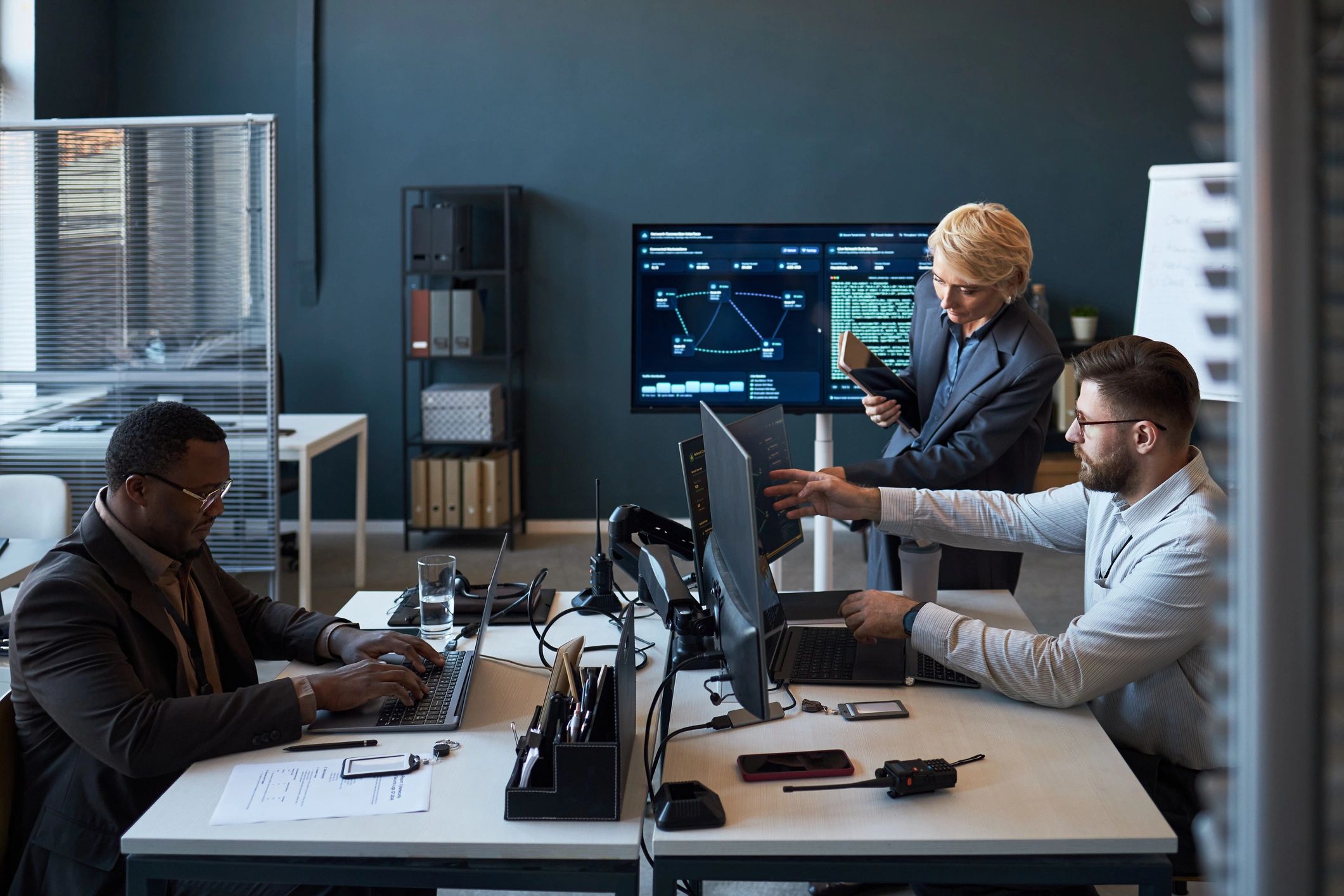 Consulting team reviewing data dashboards in an office